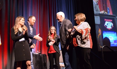 Adam Johnson congratulates Larry Limp from the stage