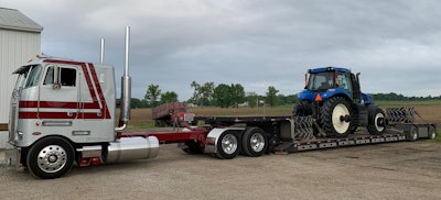 C.J. Donovan's 1984 Peterbilt 362 pulling an open-deck trailer