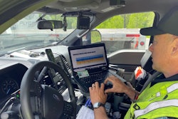 DOT officer checking truck driver's logs