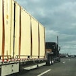 Step Deck Loaded With Storage Containers On Highway