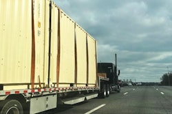 Step Deck Loaded With Storage Containers On Highway