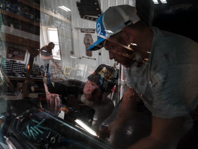 Casey and Jimmy Simpson working on the turn signal in a 1983 Kenworth cabover