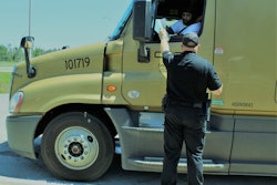 Officer handing truck driver paperwork