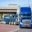 Class 8 truck hooked to tow truck
