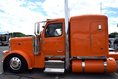 Orange Semi Casual 2024 Peterbilt 589 driver side profile
