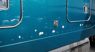 chipped paint from bullets on Marcus Sommers' 2001 Peterbilt 379