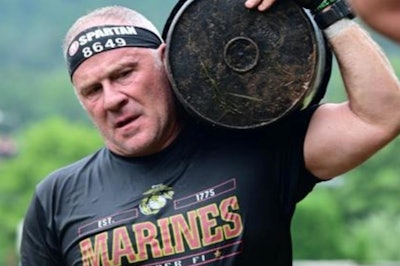Francis Junto carrying a concrete bucket