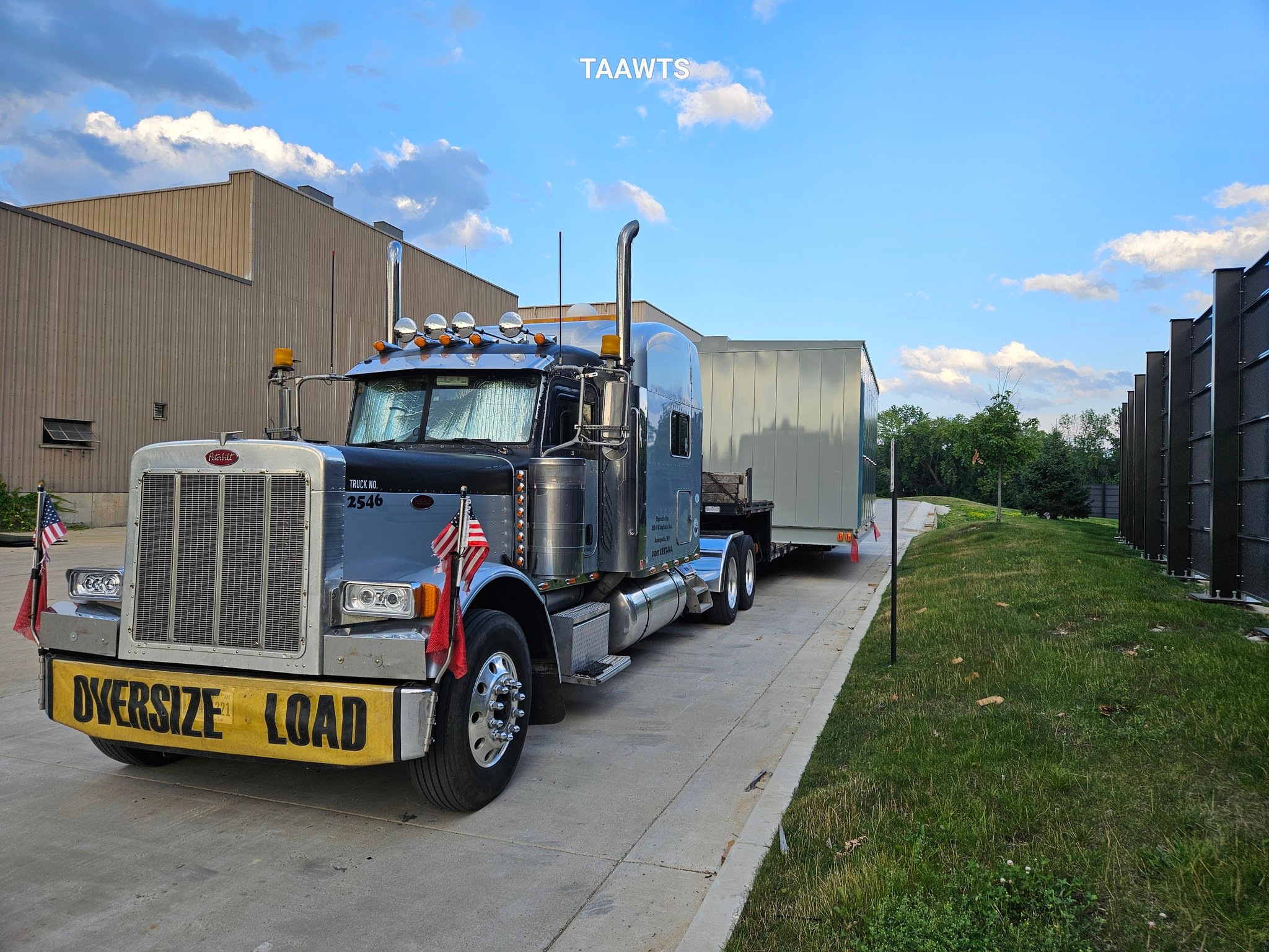 The Schmitts' truck hauling an oversize load, caught between a rock and a hard place as state permitting websites fall to the massive outage.