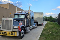 The Schmitts' truck hauling an oversize load, caught between a rock and a hard place as state permitting websites fall to the massive outage.