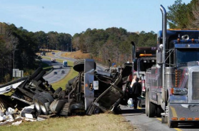 tow truck next to a crashed semi-truck
