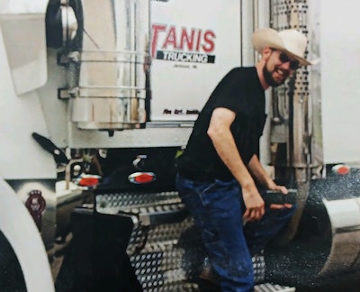 Brett DeWall, on step of truck