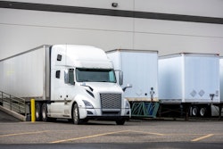 trucks and van trailers backed to dock