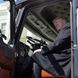 Donald Trump sitting in the cab of a semi truck
