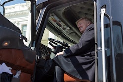 Donald Trump sitting in the cab of a semi truck