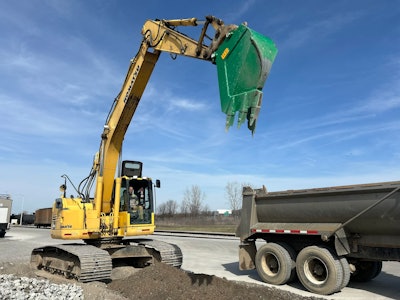 werk-brau reverse v line bucket on excavator raised above truck