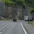 Truck On Mountain Highway Making Turn Ahead