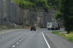 Truck On Mountain Highway Making Turn Ahead