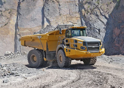 Bell B45E 4x4 dump truck with full bed in rock quarry