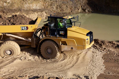 Cat 745 dump truck in thick mud