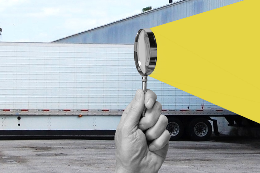 illustration of magnifying glass looking at a trailer