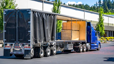 Conestoga flat loaded with pallets