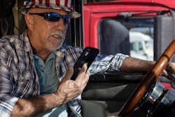 Driver Looking At Smartphone While Parked