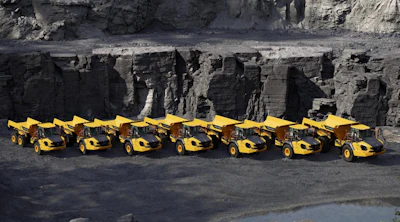 a lineup of volvo dump trucks