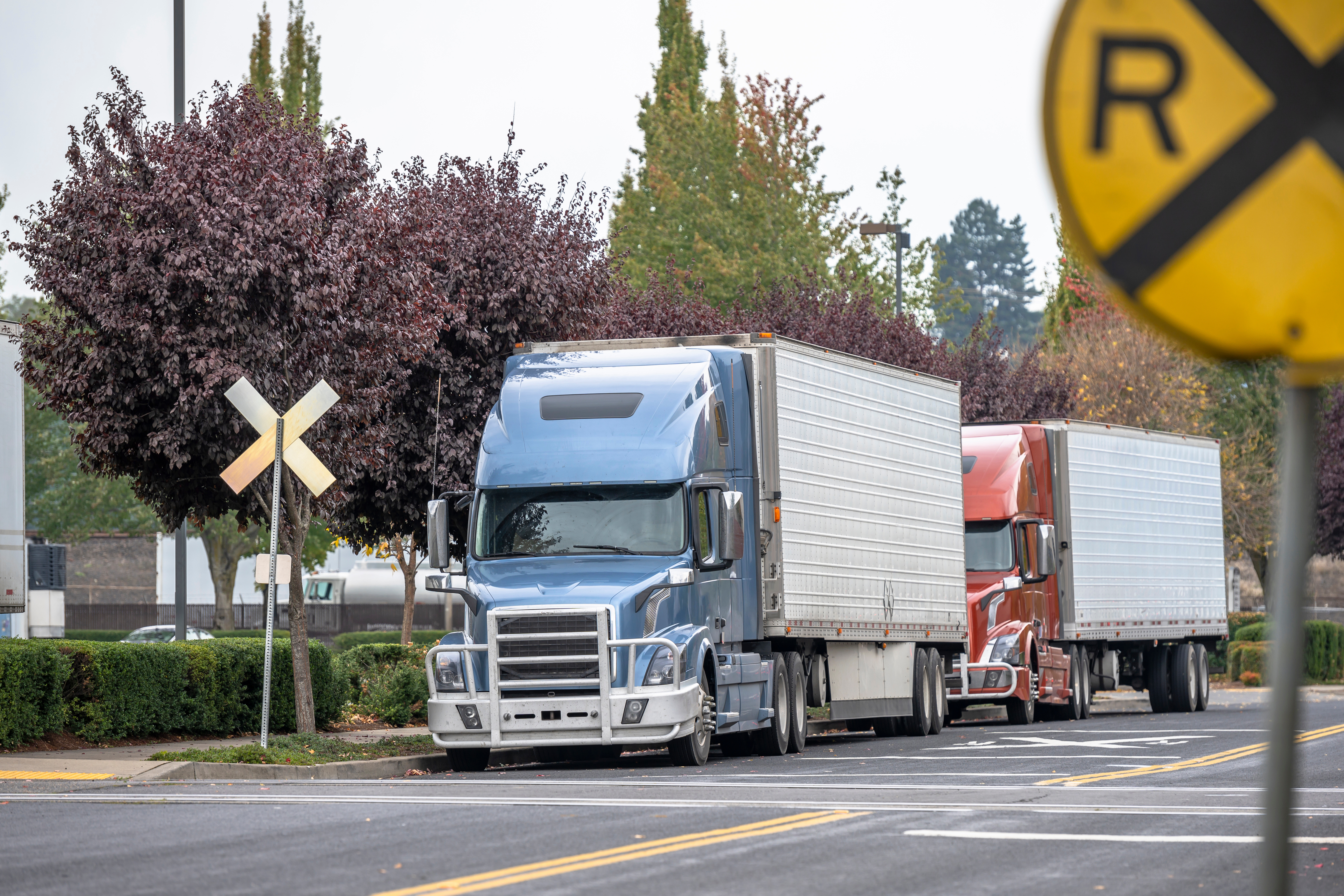 trucks at railroad crossing