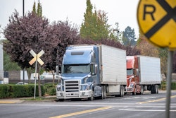 trucks at railroad crossing