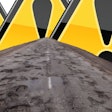 Pot-holed road and alert triangles.