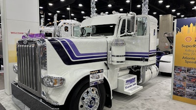 One of the 2025 Shell Rotella SuperRigs calendar trucks -- Hoewing Trucking's 'Purple Grain' 2023 Peterbilt 389 driven by Kevin Benson -- was on display at the Mid-America Trucking Show to promote the 2025 SuperRigs competition.