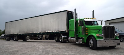 The 2016 Peterbilt 389 is shown outside the small fleet's shop hooked to a 2024 reefer ready to roll to the site of the truck show.
