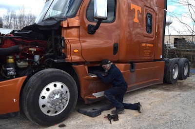 Lead shop man Andy Newbolds here is pictured working on owner-operator Dale Sutberry's truck, purchased by Wilson and company from his widow after the news of Sutberry's passing. Wilson planned to keep the Tennessee Vols T on the side of the rig just as it is.