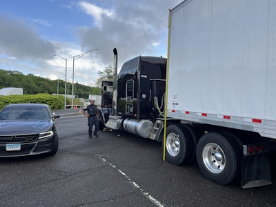 An eagle-eyed Connecticut DOT inspector flags a Kenworth for hauling a trailer just one inch too tall.