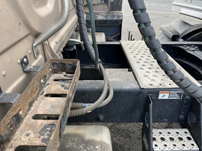 See the tiny bright spot on the frame? Is that grounds for a violation in your opinion? The hose itself did not show wear.