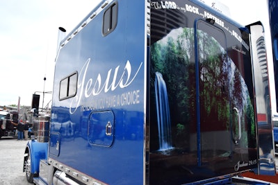 The sleeper today features a striking waterfall-and-forest mural on the rear, along with bold scripture references from Joshua in the Bible and the message along the driver's side: “Jesus -- the reason you have a choice.”