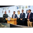Florida Attorney General James Uthmeier (podium) and Bay County Sheriff Tom Ford (left) present the results of an investigation into a cash-for-credentials scheme in Florida.