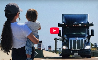This was the cover image for the video release, overlaying the picture of the young woman holding a child to make it look like they could be be run over, essentially, by the Peterbilt here outfitted with the Aurora Innovations company’s Driver system.