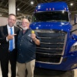 Landstar President and CEO Frank Lonegro presents the keys to a brand-new 2026 Freightliner Cascadia to Landstar All-Star Truck Giveaway Winner and new Landstar Million Mile Safe Driver George Eason.