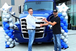 Landstar President and CEO Frank Lonegro, left, awards truck winner and Landstar owner-operator Christian Sanchez Cantù with the keys to his new rig.