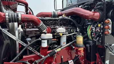 The engine is painted to match the truck’s exterior with custom hand-drawn pinstriping and lettering to really set it apart.
