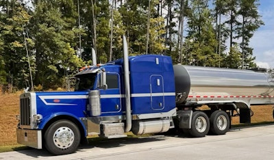Blue Tractor With Turnage Tanker