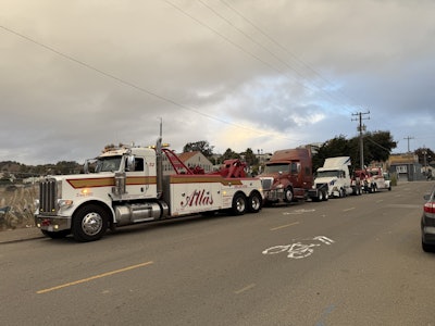 Here two fully outfitted purpose-built tow trucks do the job one driver's improvised 'ingenuity' accomplished with just one, a chain and a metal pipe.