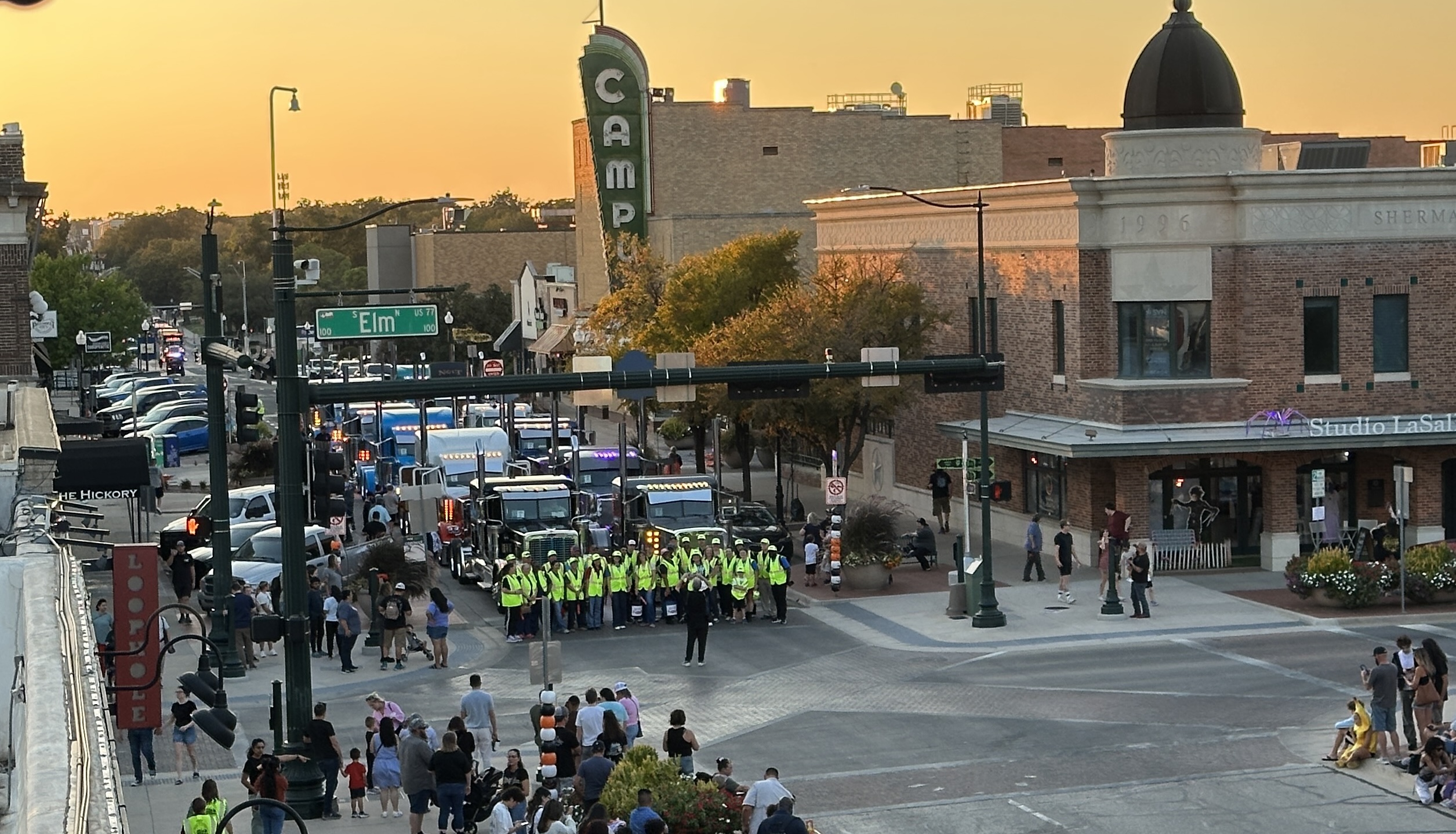 Volunteers raising funds for United Way of Denton County posed for a quick photo in front of the Peterbilt trucks staged in downtown Denton ahead of the 8th annual Peterbilt Pride & Class Parade.