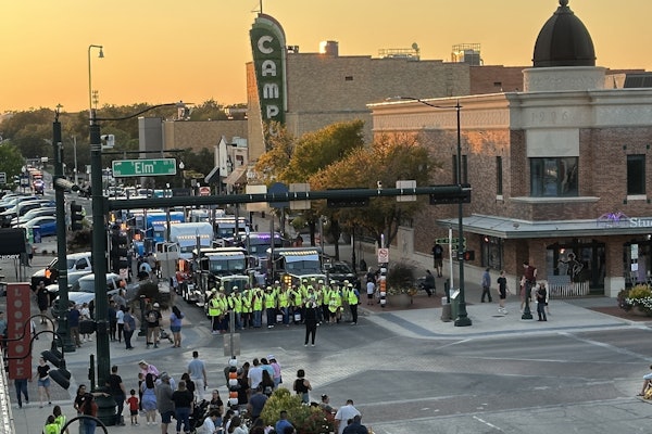 Volunteers raising funds for United Way of Denton County posed for a quick photo in front of the Peterbilt trucks staged in downtown Denton ahead of the 8th annual Peterbilt Pride & Class Parade.