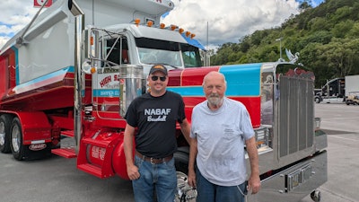 Owner-operator Richard Puckett (right) is shown with his 2002 Peterbilt 379 dump truck and Elijah Webb (left), who painted the rig and did the bodywork to finish the rebuild.