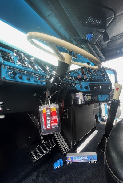 The black, classic interior is now trimmed in blue, appearing as new as when it first rolled off the assembly line. He added custom switches trimmed in red to offset the black and American flags on the brake knobs. He installed a refrigerator and microwave for more creature comforts of a home on the road.