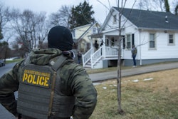 An ICE officer from provides overwatch during a targeted enforcement action on January 31, 2025.