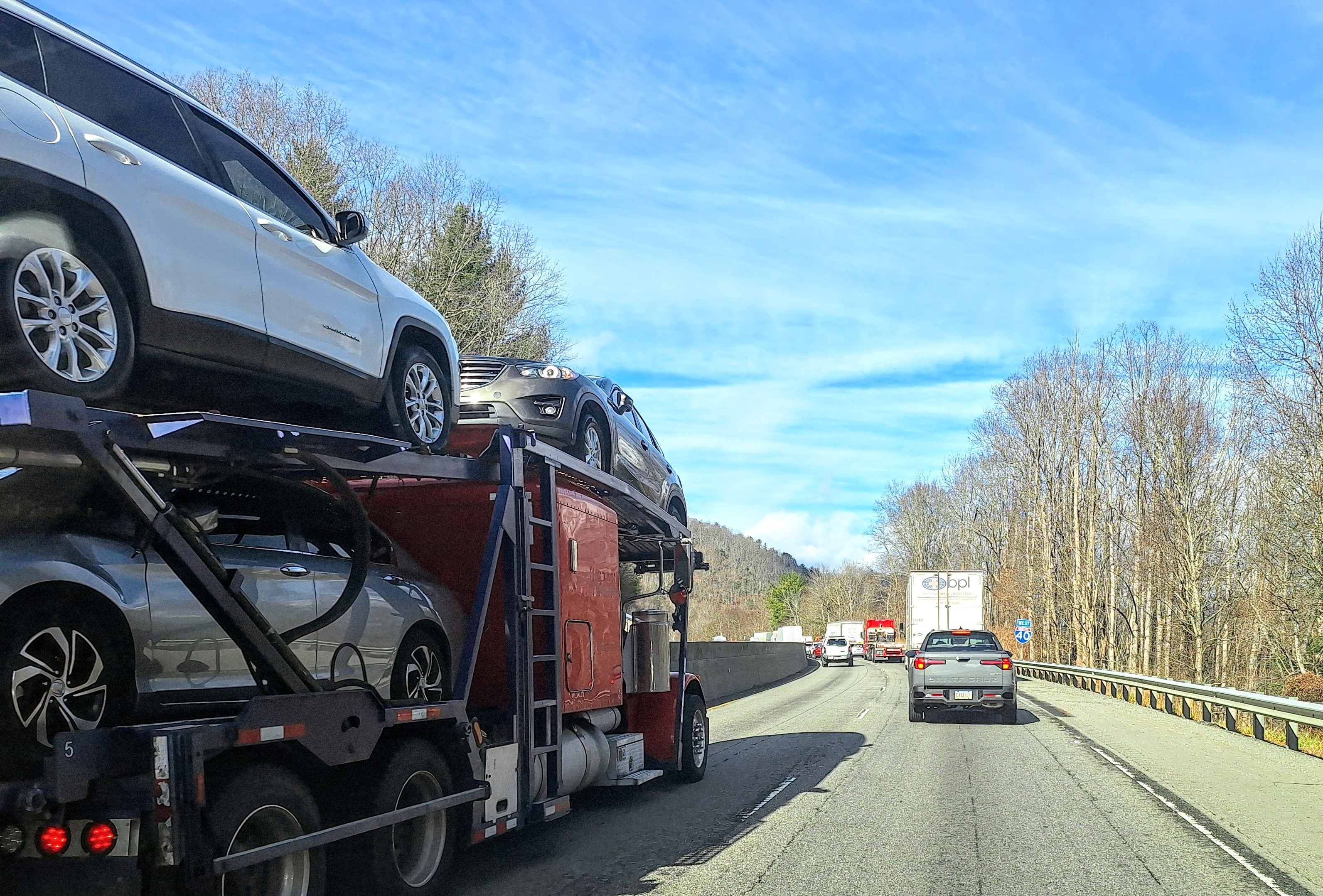 Car Hauler On Highway Left Lane In Traffic