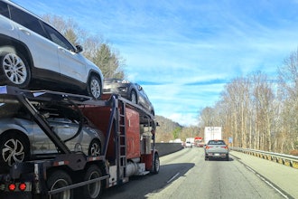 Car Hauler On Highway Left Lane In Traffic